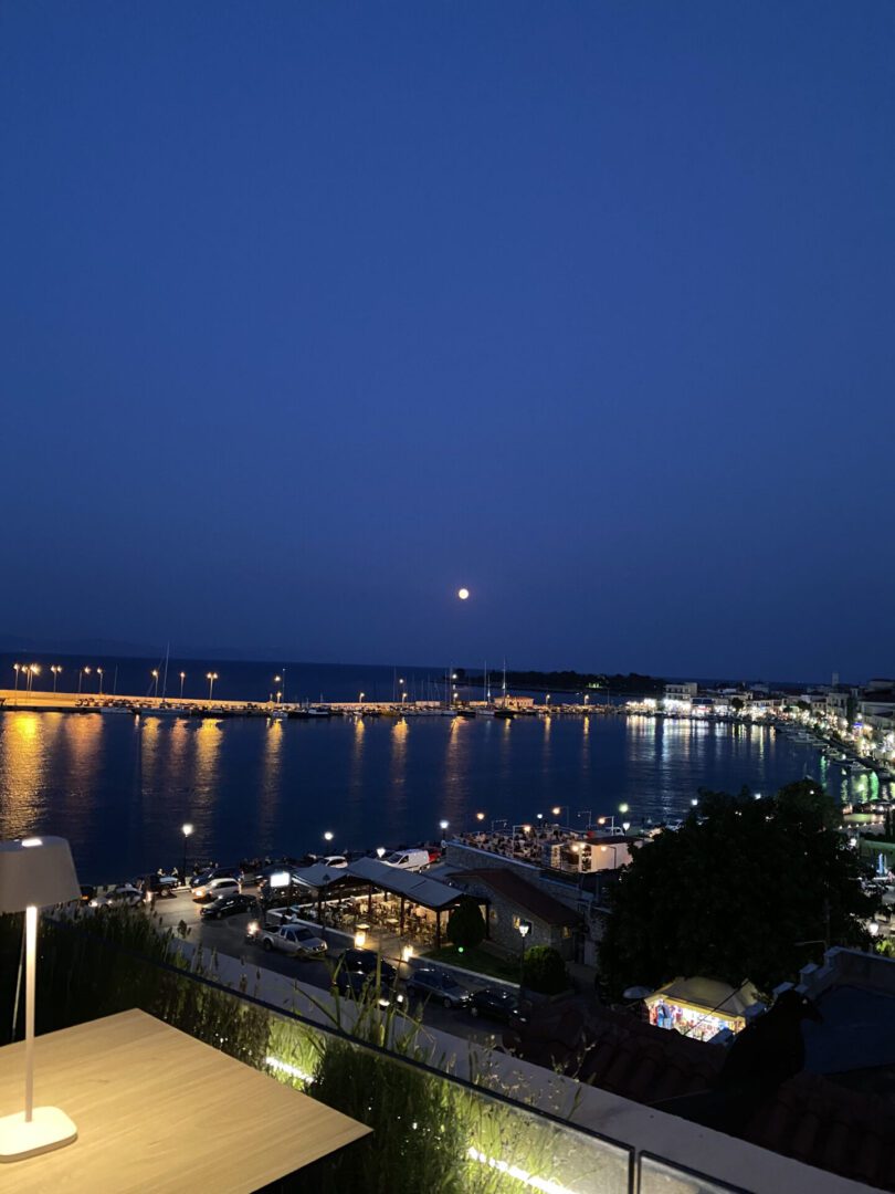 Night view of a calm river with lights reflecting on the water.