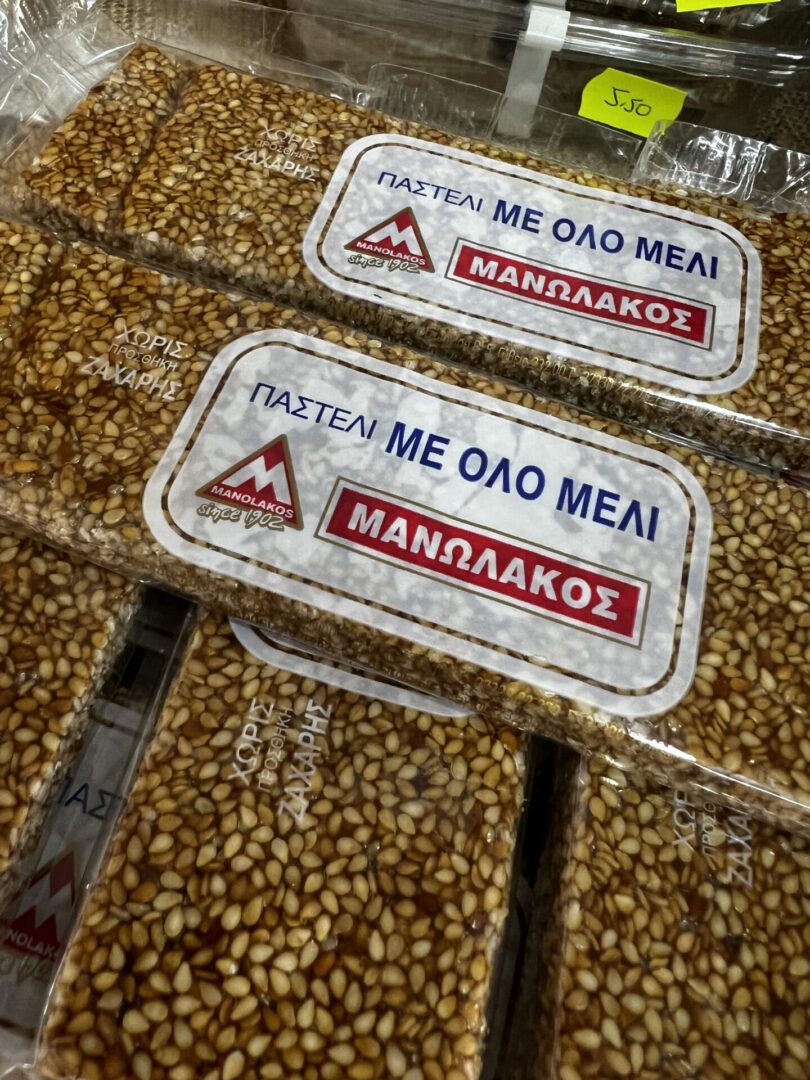 Close-up of packaged honeycomb with Greek labels.