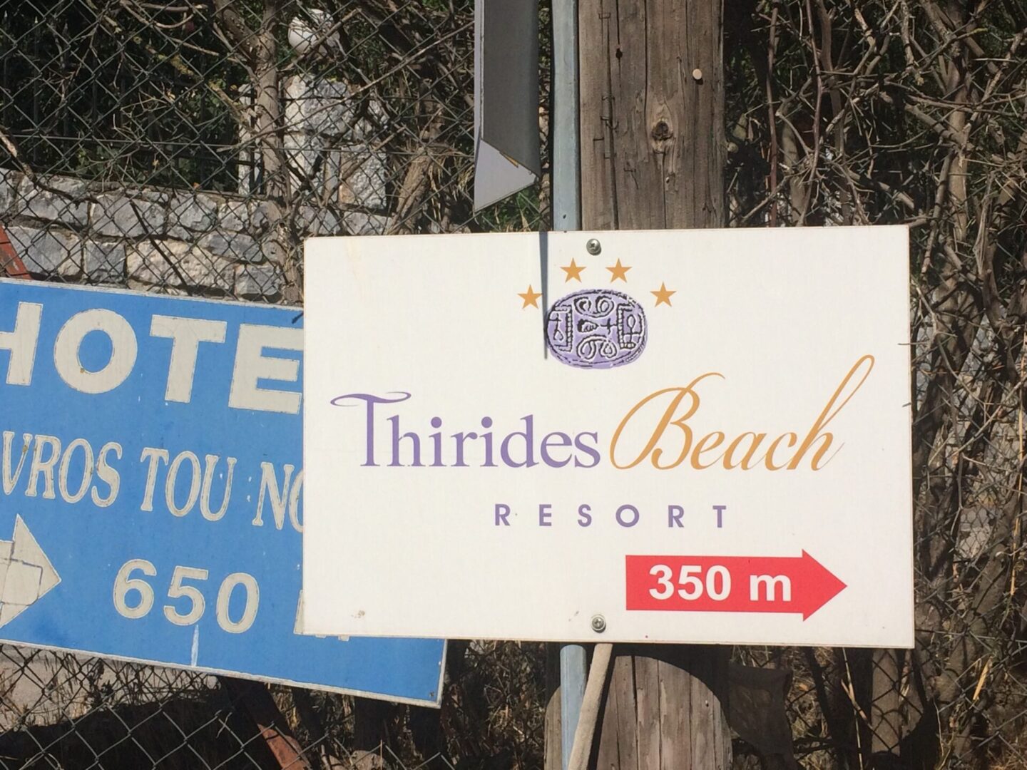 Sign indicating Thirides Beach Resort is 350 meters away.
