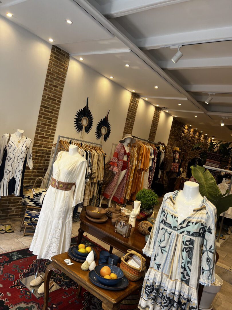 Boutique interior with mannequins dressed in bohemian-style clothing and accessories.