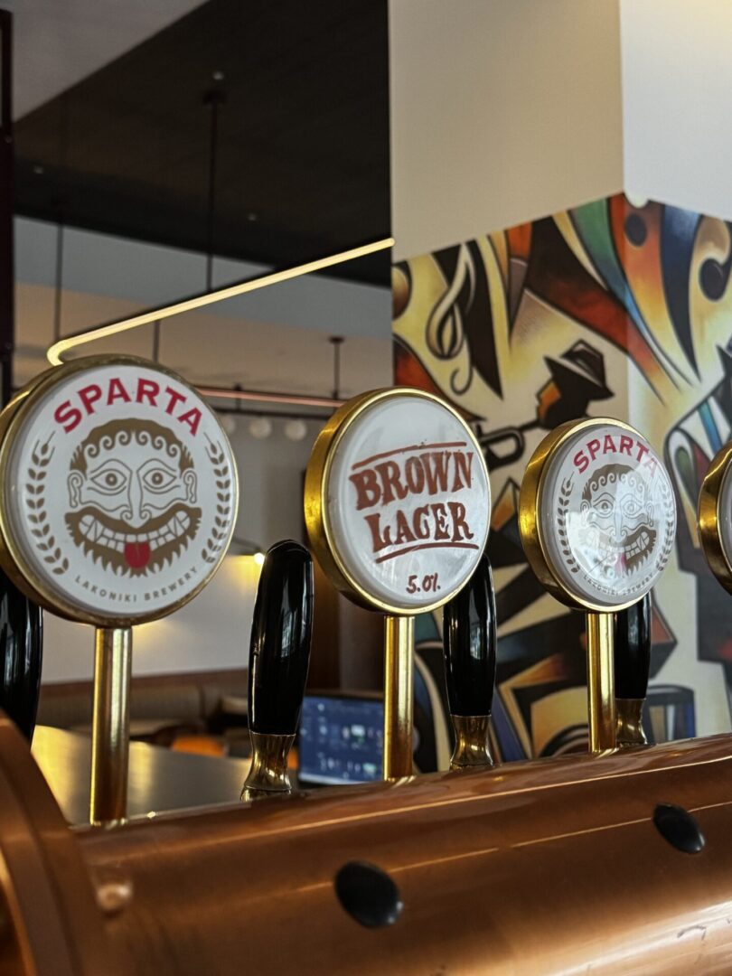Three vintage beer taps labeled Sparta, Brown Lager, and Pilsner.