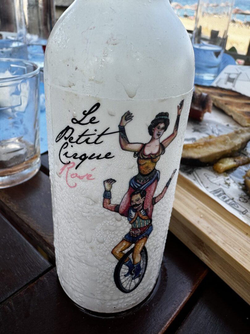 A bottle labeled 'Le Petit Cirque' with a circus-themed illustration.