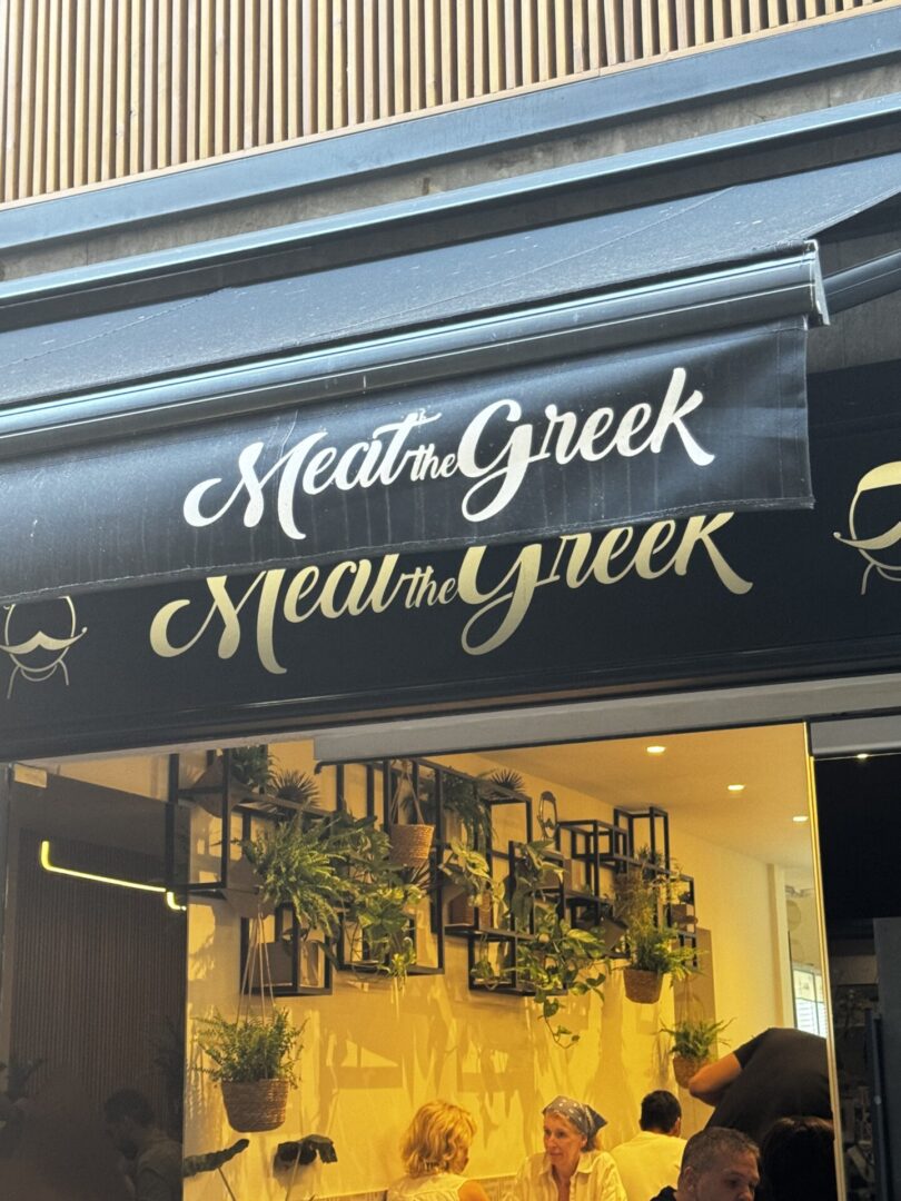 Greek restaurant exterior with diners inside