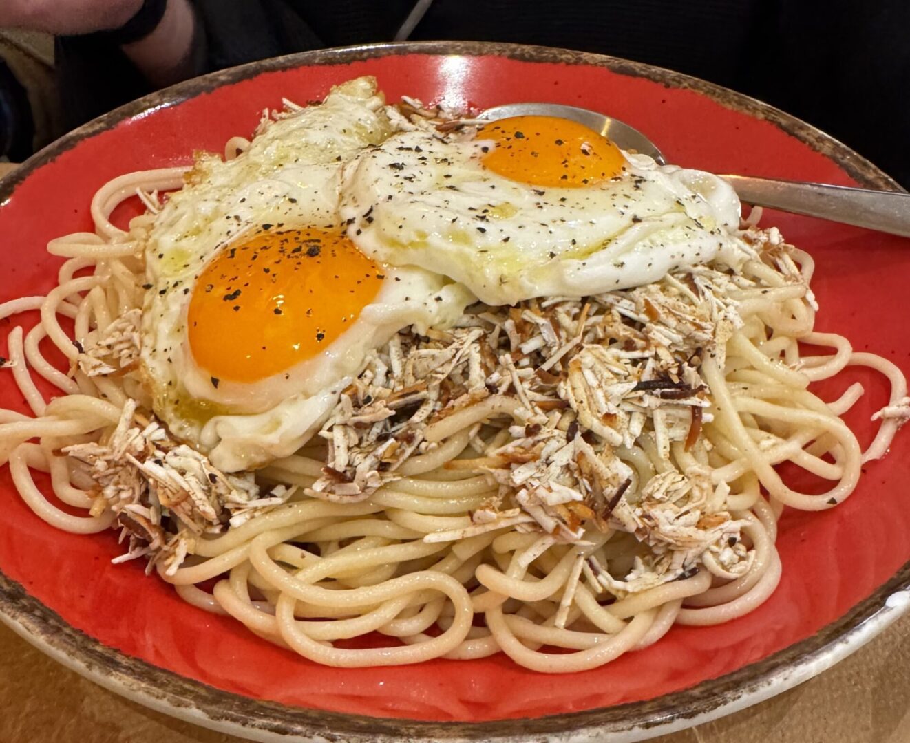 Pasta dish with sunny-side-up eggs