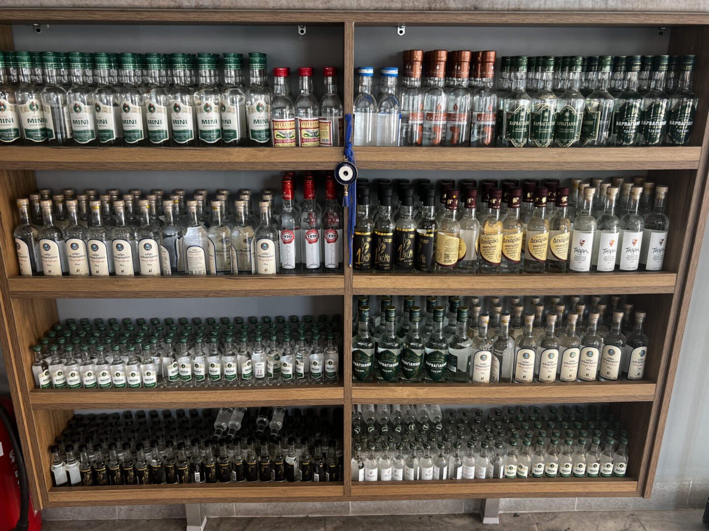 Shelves filled with various glass bottles containing spices and herbs.