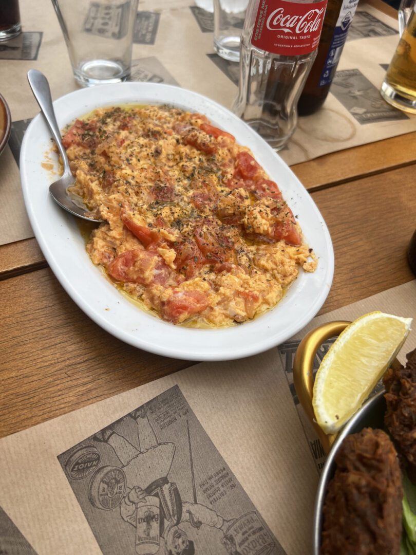 A plate of risotto with tomato sauce on a wooden table.