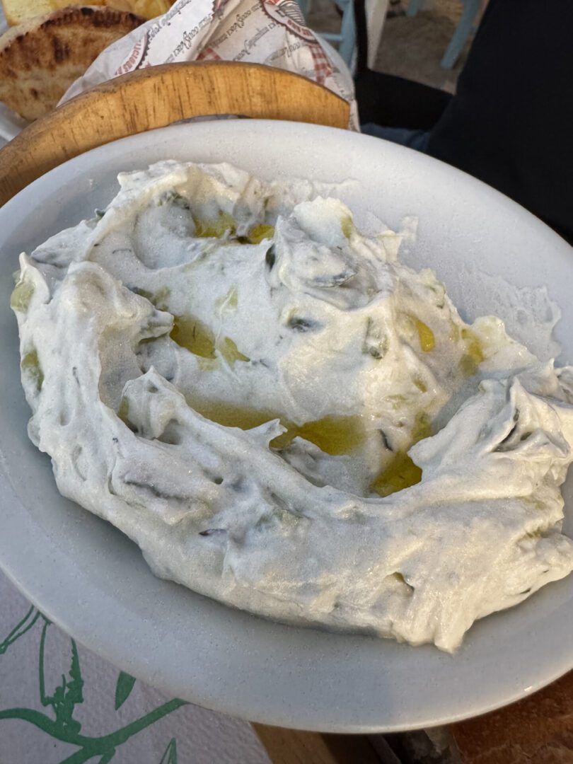 A bowl of creamy white dip with olive oil drizzle.