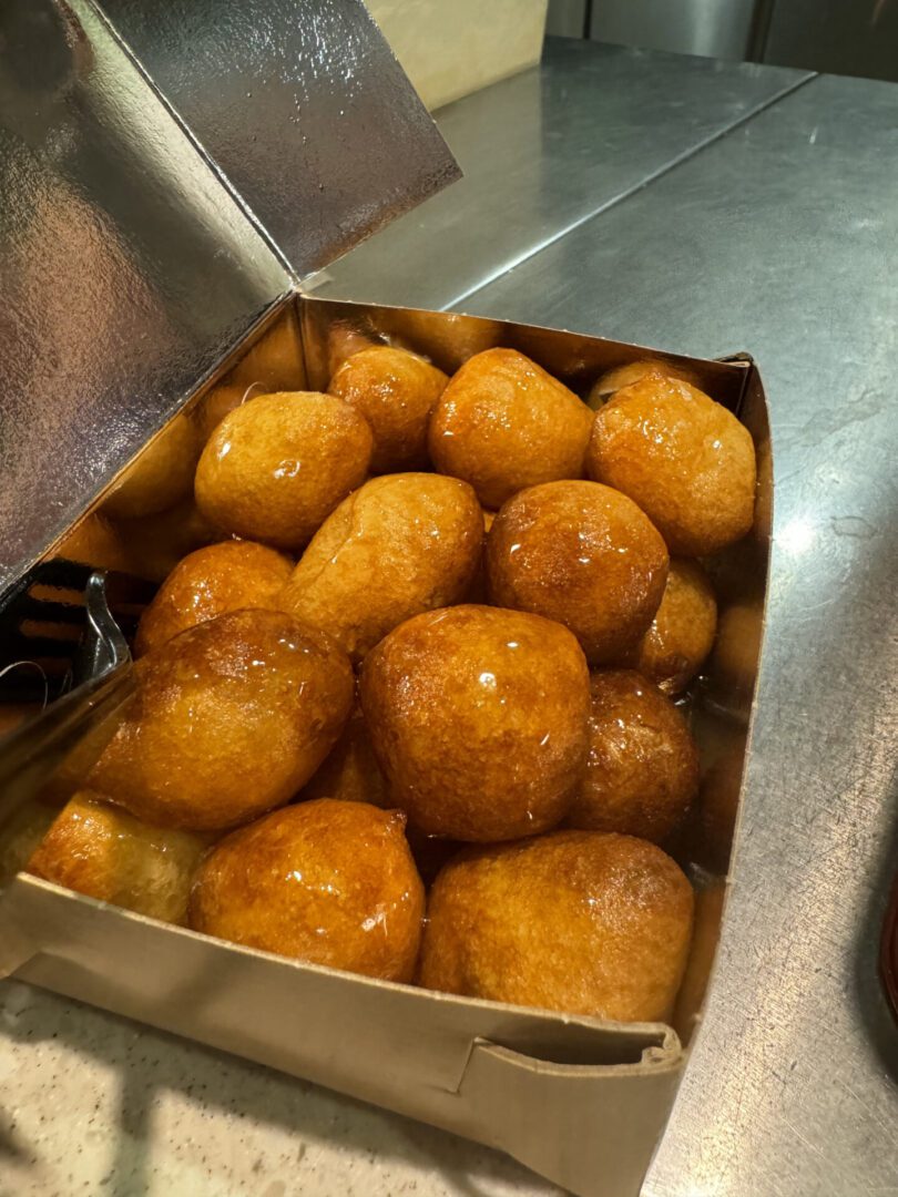 Golden fried dough balls cooking in hot oil.