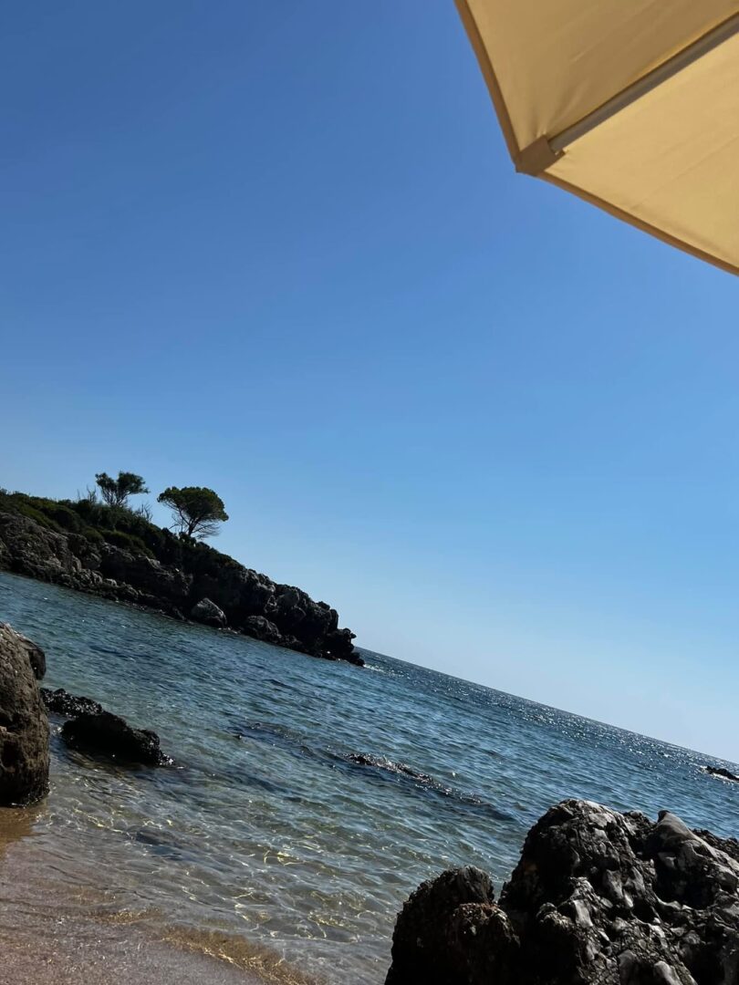 Coastal view with clear blue sky and calm sea waters.